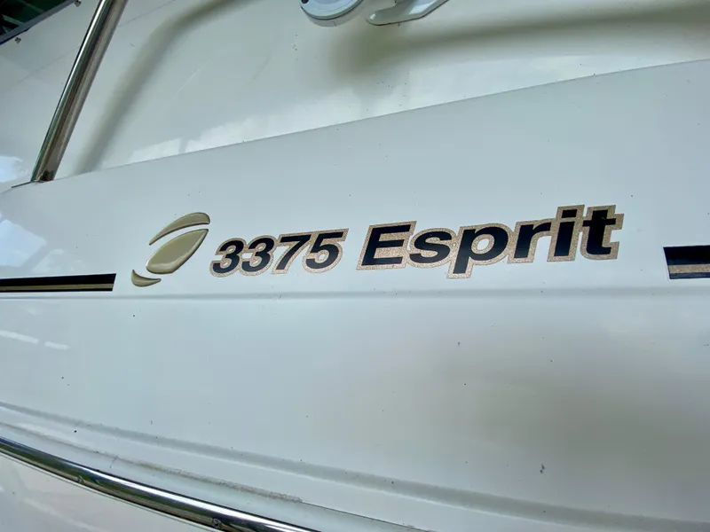 Slide: The Image of 1999 Cruisers Yachts 3375 Esprit logo on white boat exterior. - 5
