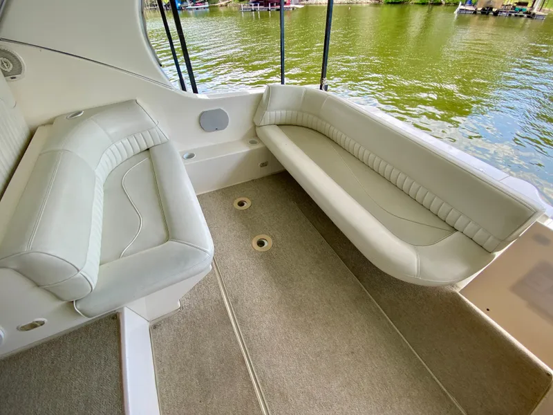 Slide: The Image of 1999 Cruisers Yachts 3375 Esprit interior with beige seating and lake view. - 8