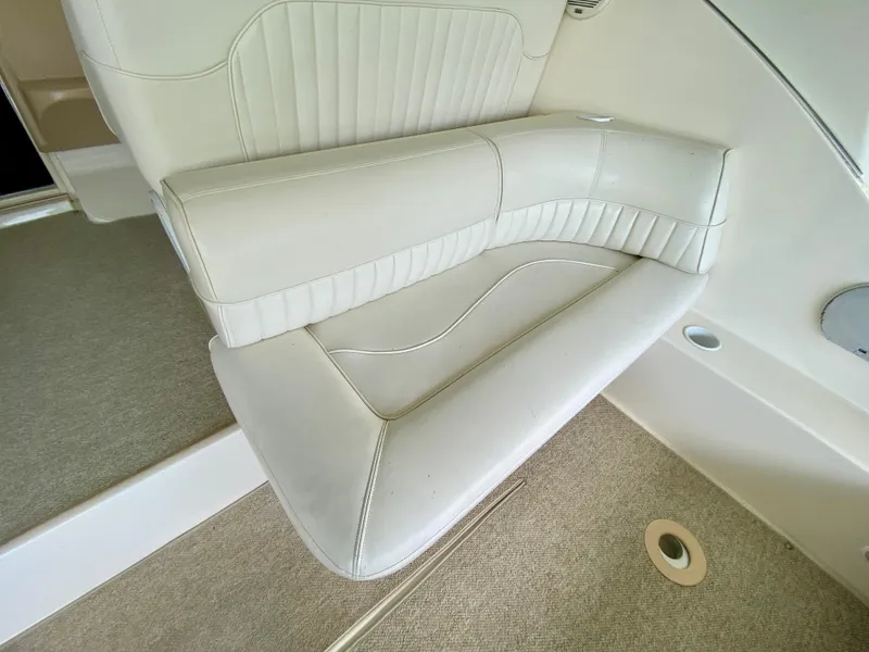 Slide: The Image of White leather seating on 1999 Cruisers Yachts 3375 Esprit, featuring elegant stitching and design. - 9