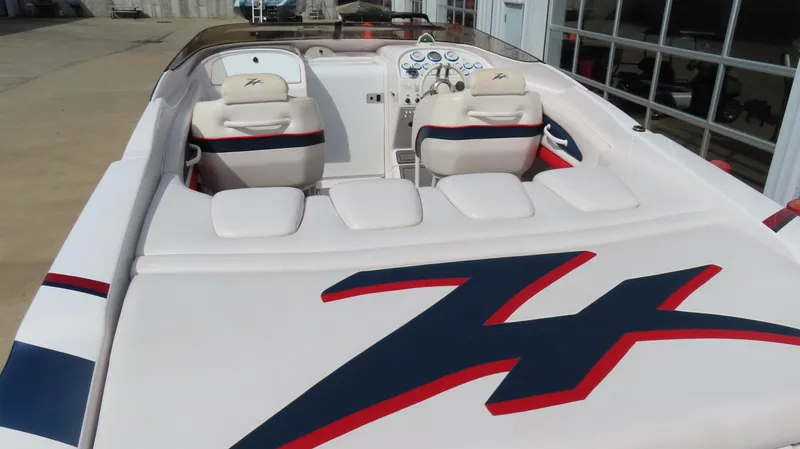 Slide: The Image of 2000 Donzi 28ZX boat interior with white seating and dashboard, featuring red and blue accents. - 10