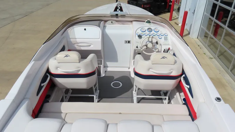 Slide: The Image of 2000 Donzi 28ZX boat interior with white seating and dashboard controls. - 11