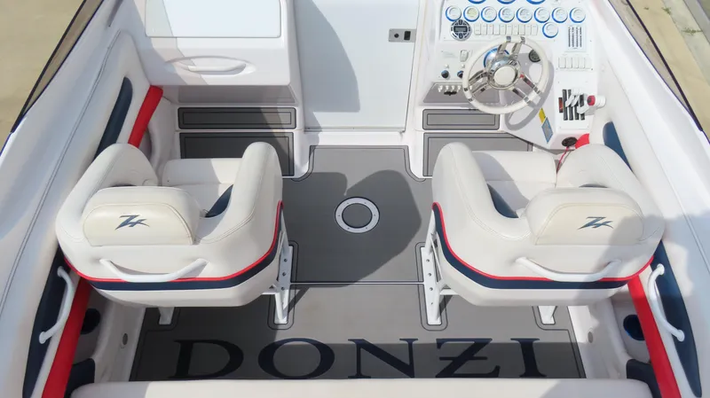 Slide: The Image of 2000 Donzi 28ZX boat interior with white seats, steering wheel, and dashboard controls. - 12