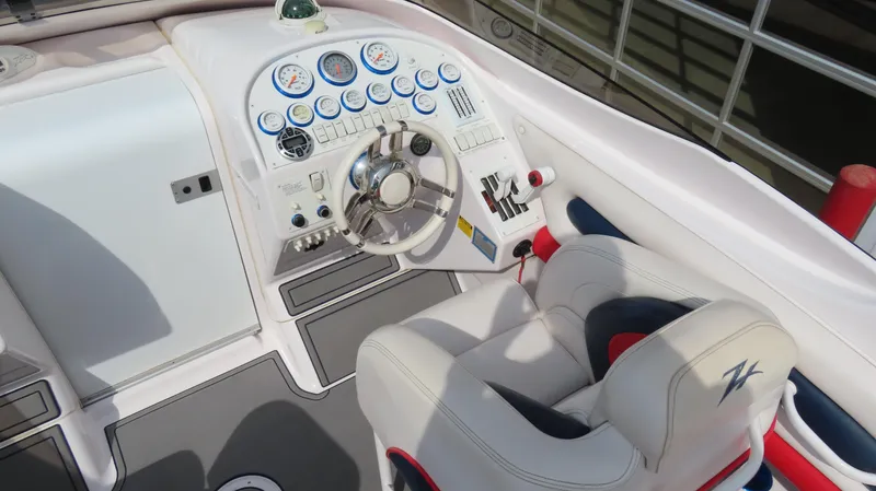 Slide: The Image of Cockpit of 2000 Donzi 28ZX boat with steering wheel and control panel. - 13