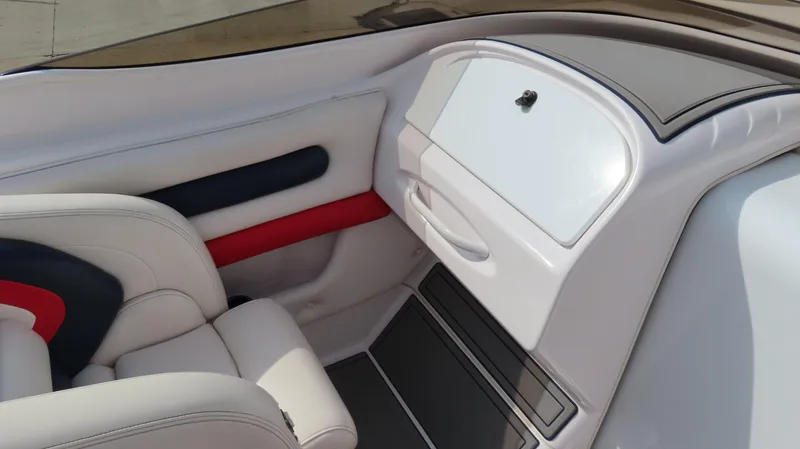 Slide: The Image of Interior of a 2000 Donzi 28ZX boat, featuring white and red seating. - 15