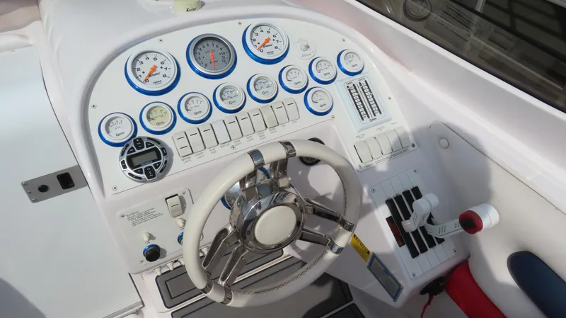 Slide: The Image of Dashboard of a 2000 Donzi 28ZX boat with gauges and steering wheel. - 18