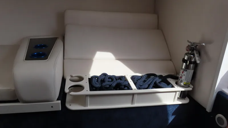 Slide: The Image of Interior of 2000 Donzi 28ZX boat with seating, cup holders, rope, and fire extinguisher. - 24