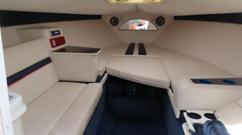 Slide: The Image of Interior of a 2000 Donzi 28ZX boat with beige seating and modern amenities. - 27