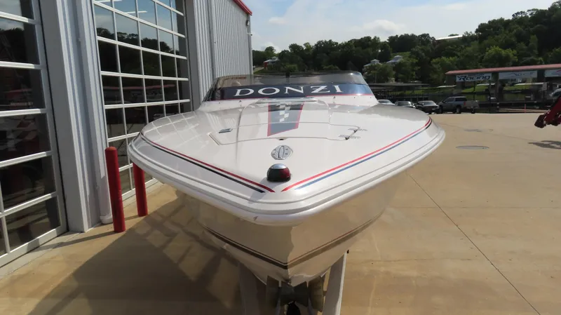 Slide: The Image of 2000 Donzi 28ZX speedboat displayed outdoors near a building. - 3