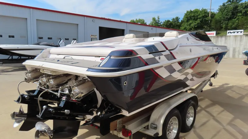 Slide: The Image of 2000 Donzi 28ZX speedboat on trailer, featuring sleek design and powerful engines. - 5