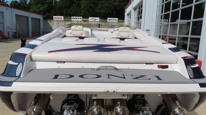 Slide: The Image of 2000 Donzi 28ZX speedboat with dual engines, parked at a marina. - 8