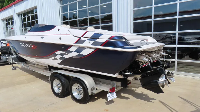 Slide: The Image of 2000 Donzi 28ZX speedboat on trailer, featuring sleek design and vibrant graphics. - 9