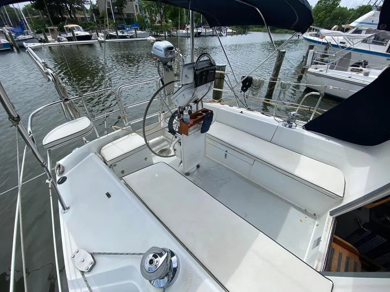 Slide: The Image of Cockpit of 1995 Catalina 36 MkII sailboat with seating and steering wheel, docked at marina. - 14