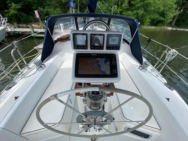 Slide: The Image of Cockpit of 1995 Catalina 36 MkII sailboat with navigation instruments and steering wheel. - 16
