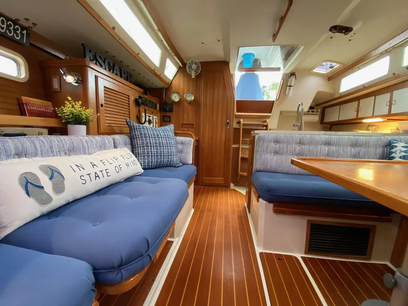 Slide: The Image of Interior of a 1995 Catalina 36 MkII sailboat with cozy seating and nautical decor. - 23