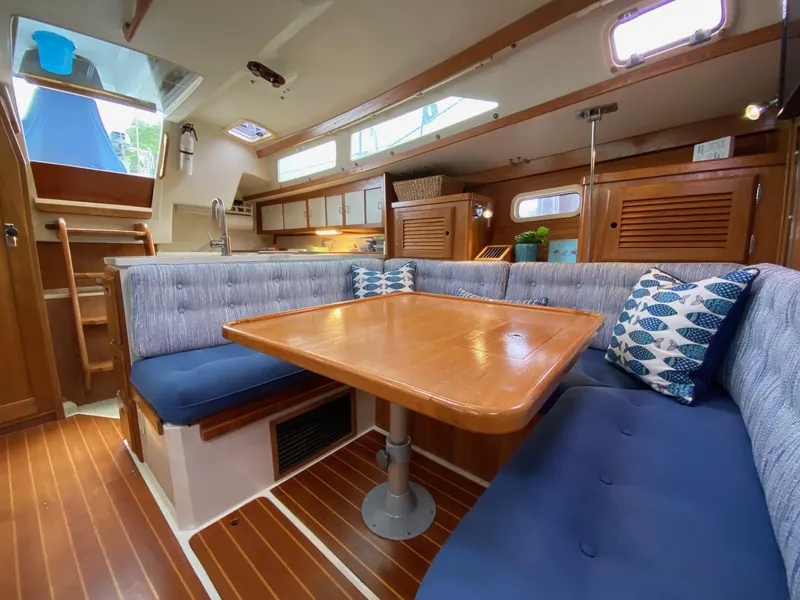 Slide: The Image of Interior of 1995 Catalina 36 MkII sailboat with cozy dining area and wooden finishes. - 24