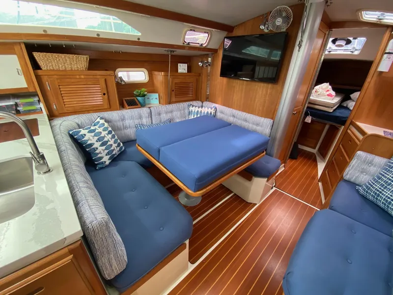 Slide: The Image of Interior of a 1995 Catalina 36 MkII sailboat with blue seating and wooden accents. - 26
