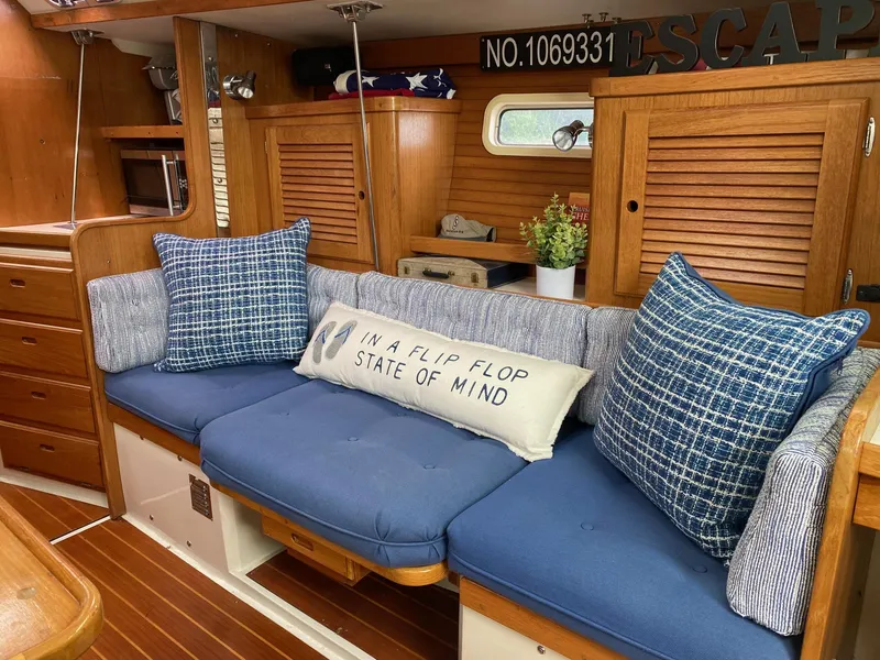 Slide: The Image of Cozy interior of 1995 Catalina 36 MkII sailboat with blue cushions and decorative pillows. - 28