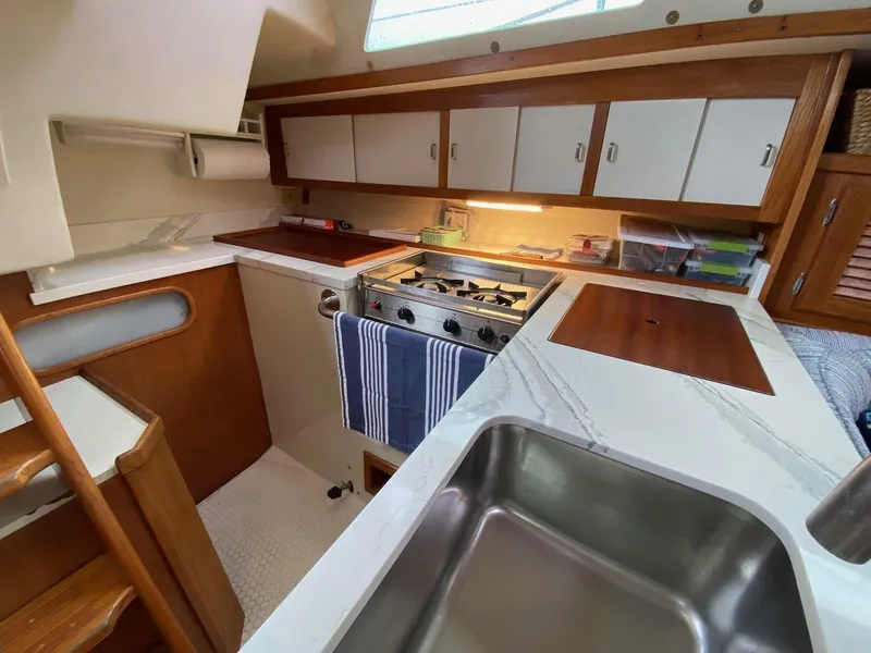 Slide: The Image of Catalina 36 MkII 1995 yacht kitchen with stove, sink, and storage cabinets. - 35