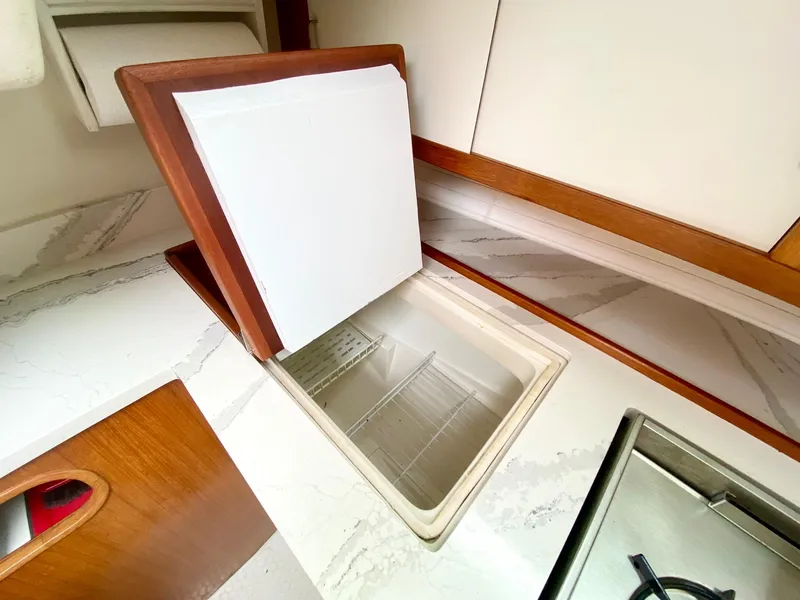 Slide: The Image of Galley of 1995 Catalina 36 MkII sailboat with open storage compartment. - 37