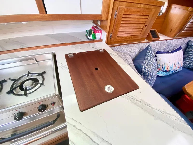 Slide: The Image of Galley of 1995 Catalina 36 MkII sailboat with stove, countertop, and seating area. - 38