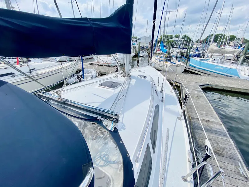 Slide: The Image of Catalina 36 MkII sailboat from 1995 docked at a marina, surrounded by other boats. - 4