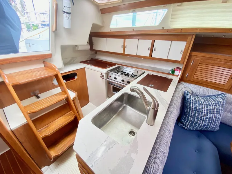 Slide: The Image of Interior of 1995 Catalina 36 MkII sailboat with kitchen and seating area. - 41