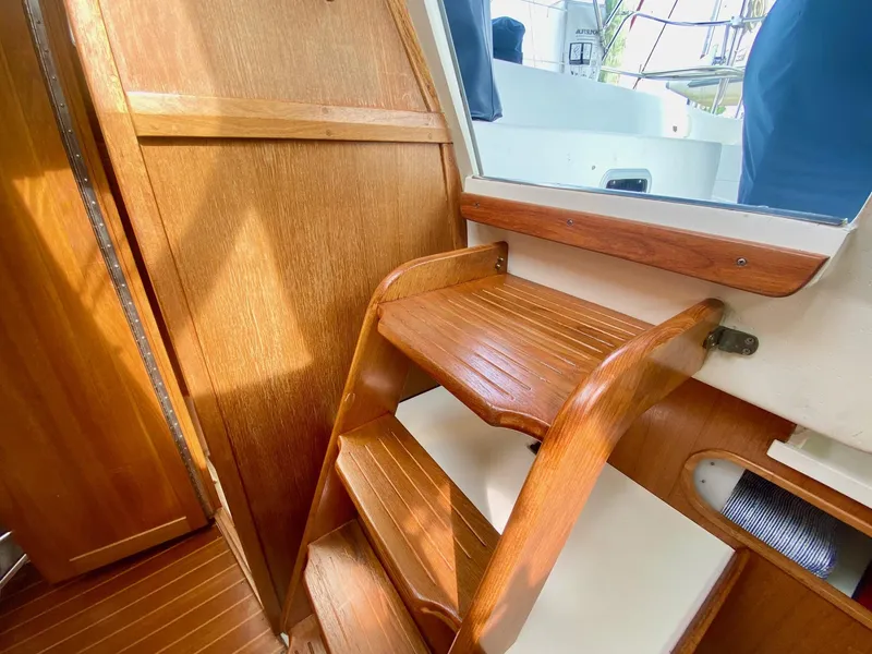 Slide: The Image of Wooden interior stairs of a 1995 Catalina 36 MkII sailboat, leading to the deck. - 42