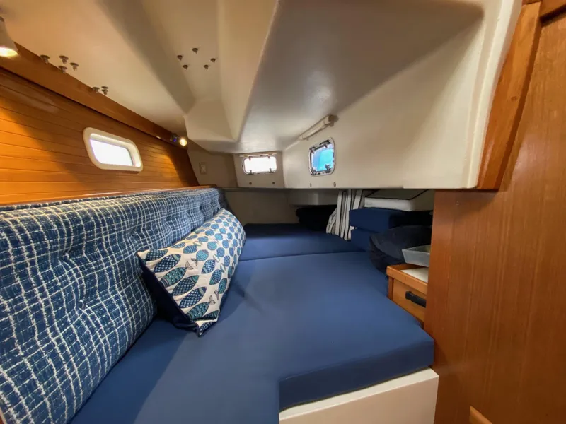 Slide: The Image of Interior of 1995 Catalina 36 MkII sailboat with blue cushions and wooden accents. - 44