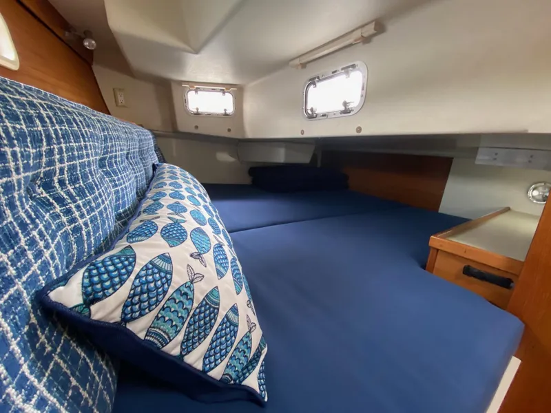 Slide: The Image of Cozy cabin interior of 1995 Catalina 36 MkII sailboat with blue bedding and fish-patterned pillow. - 46