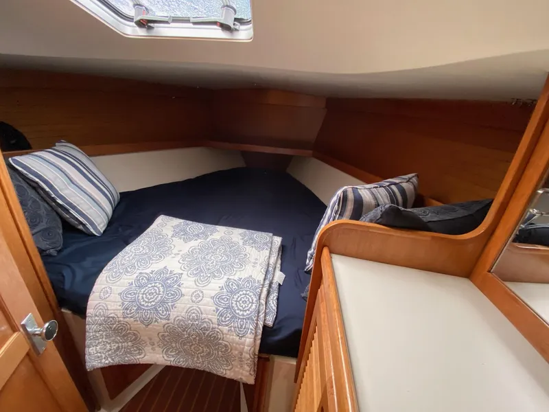 Slide: The Image of Cozy cabin interior of 1995 Catalina 36 MkII sailboat with striped pillows and patterned blanket. - 47