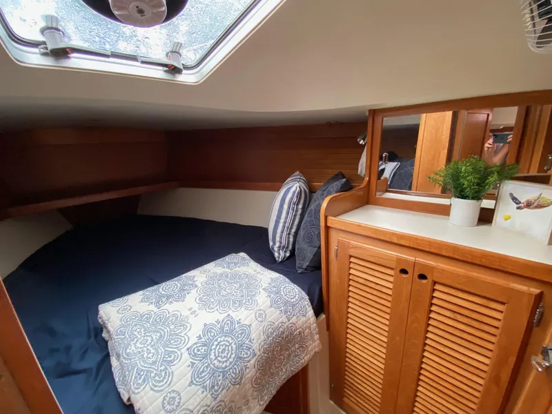 Slide: The Image of Cozy cabin interior of 1995 Catalina 36 MkII with bed, pillows, and wooden cabinetry. - 49