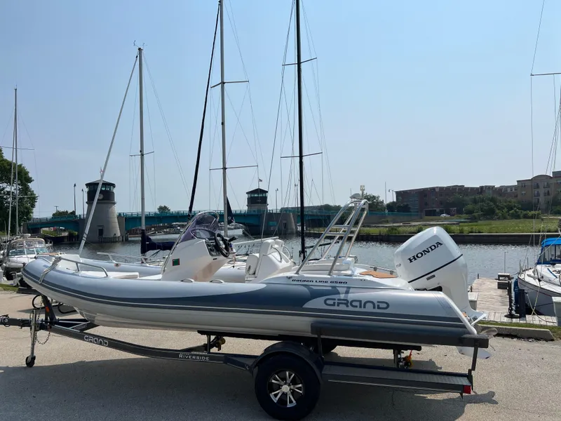 The Image of 2019 Grand G580HLF boat with Honda engine on trailer by marina. - 0