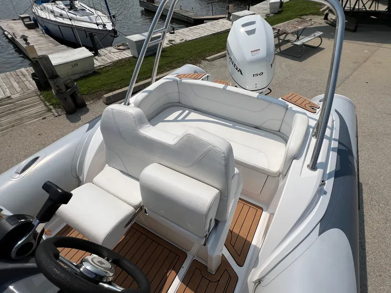Slide: The Image of 2019 Grand G580HLF boat with white seating and Honda 150 outboard motor. - 14