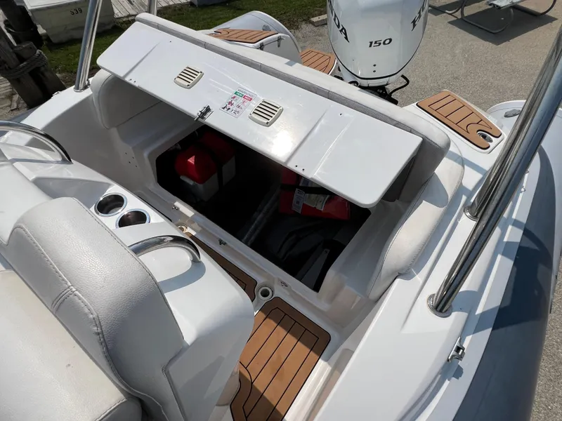 Slide: The Image of Open storage compartment on 2019 Grand G580HLF boat with Honda 150 engine. - 15