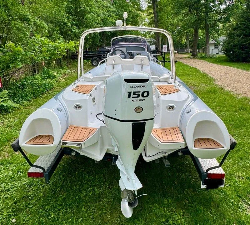Slide: The Image of 2019 Grand G580HLF boat with Honda 150 VTEC engine on grassy area. - 18