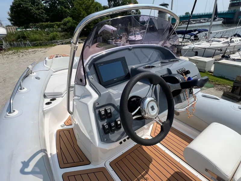 Slide: The Image of Cockpit of 2019 Grand G580HLF boat with steering wheel and control panel. - 9