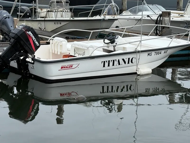 Slide: The Image of 2003 Boston Whaler 150 Sport boat named "Titanic" docked with Mercury engine. - 0