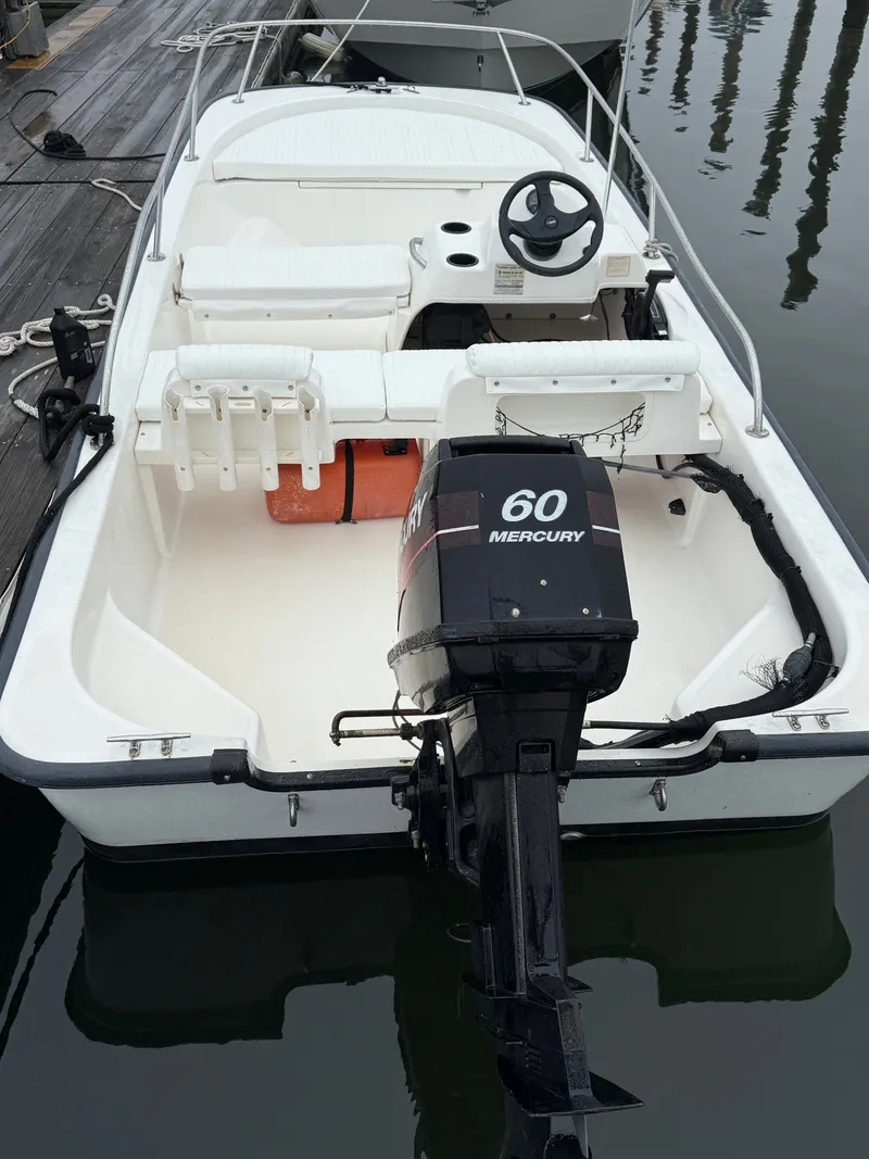 Slide: The Image of 2003 Boston Whaler 150 Sport boat with Mercury 60 engine, docked at marina. - 3