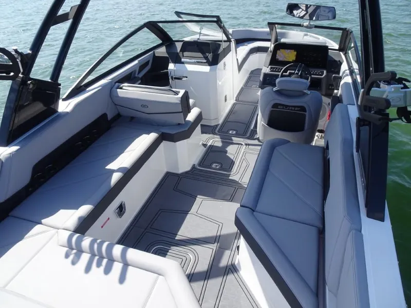 Slide: The Image of 2025 Cobalt R8 Surf boat interior with modern seating and dashboard on the water. - 10