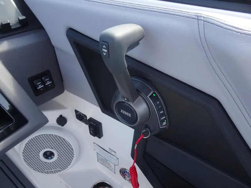 Slide: The Image of 2025 Cobalt R8 Surf boat throttle control with speaker and switches. - 14