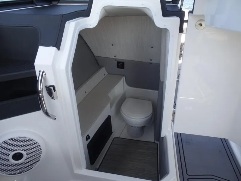 Slide: The Image of 2025 Cobalt R8 Surf boat interior with compact marine toilet. - 19
