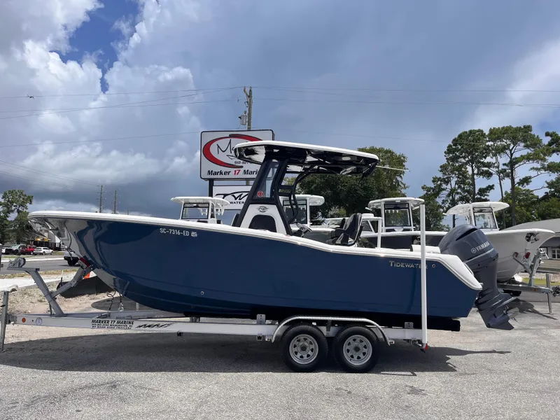 The Image of 2023 Tidewater 232 LXF boat on trailer, displayed outdoors under cloudy sky. - 1