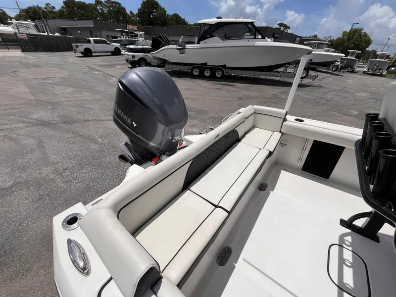 Slide: The Image of 2023 Tidewater 232 LXF boat with Yamaha outboard motor, parked in a marina. - 14