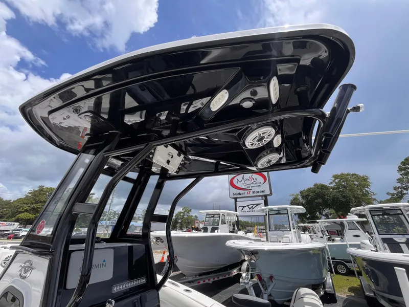 Slide: The Image of 2023 Tidewater 232 LXF boat with sleek black T-top and modern features. - 15