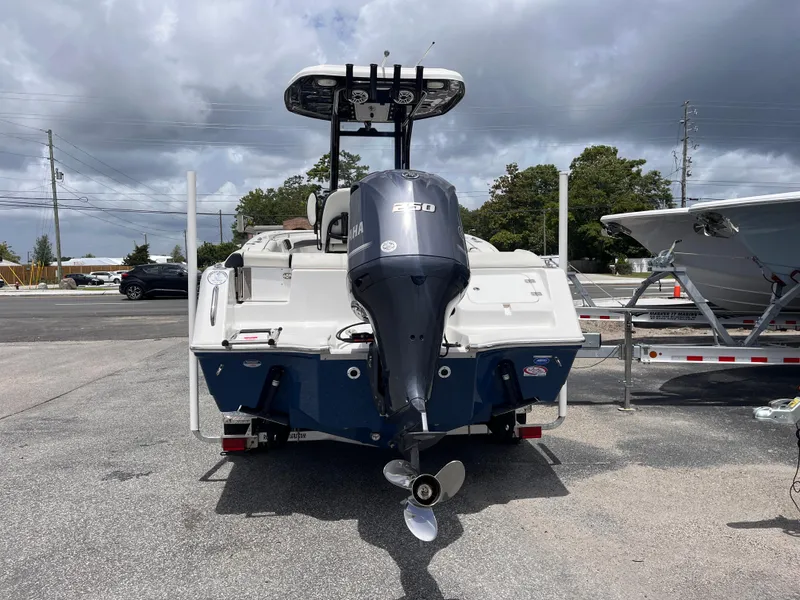 Slide: The Image of 2023 Tidewater 232 LXF boat with Yamaha outboard motor, parked on a trailer. - 4