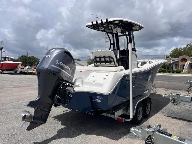 Slide: The Image of 2023 Tidewater 232 LXF boat with Yamaha engine on trailer, parked outdoors. - 5