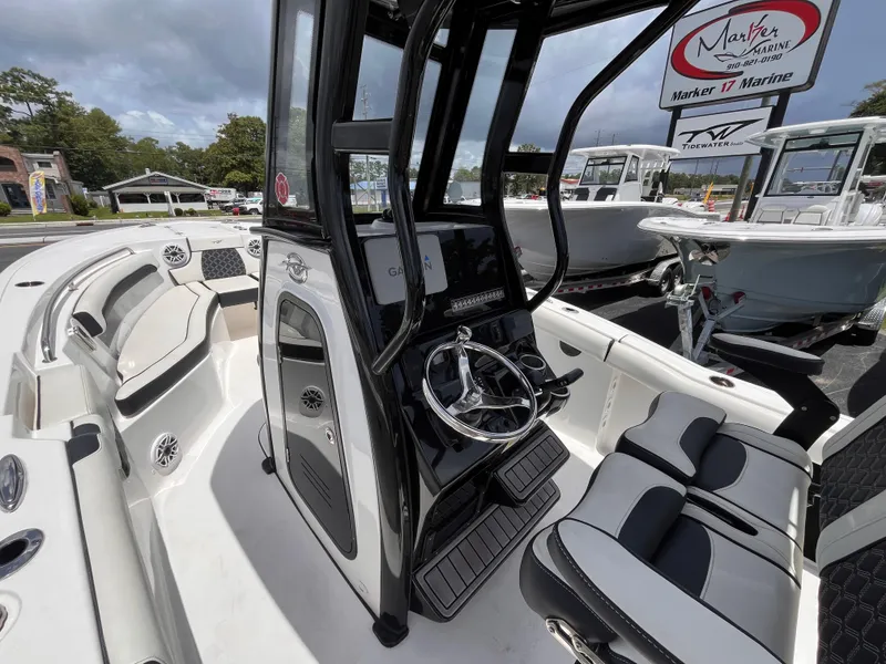 Slide: The Image of 2023 Tidewater 232 LXF boat interior with modern console and seating at Marker 17 Marine. - 8