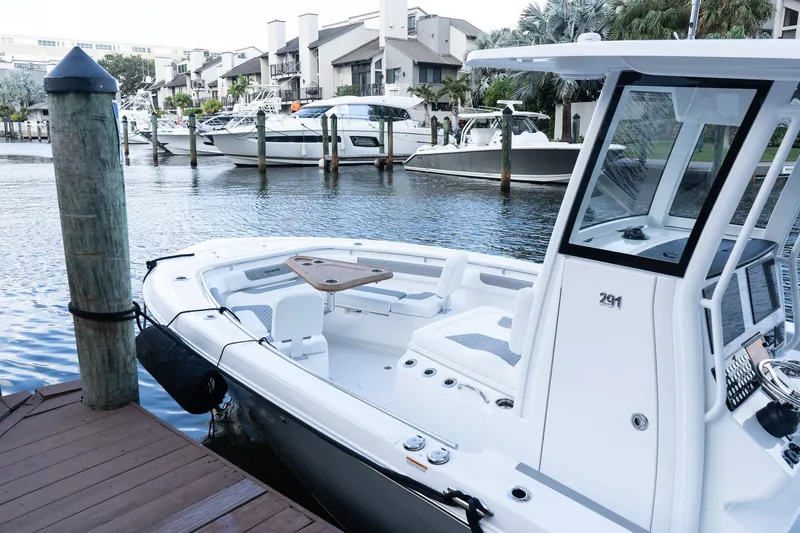 Slide: The Image of 2025 Caymas 291 HB boat docked in a marina, featuring sleek design and modern amenities. - 1