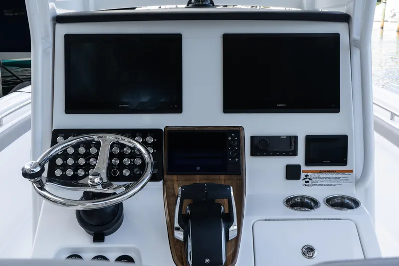Slide: The Image of 2025 Caymas 291 HB boat dashboard with dual screens and steering wheel. - 16