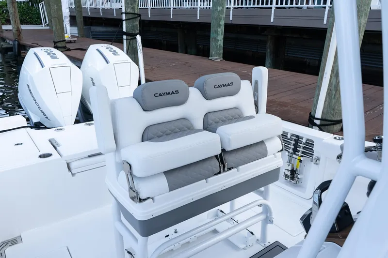 Slide: The Image of 2025 Caymas 291 HB boat interior with dual Mercury engines and cushioned seating. - 17